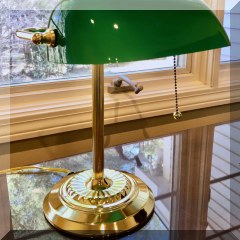D82. Brass desk lamp with green glass shade. 14”h - $32